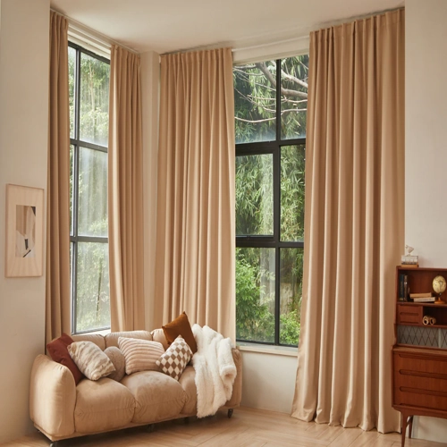 Cozy living room with full-length beige window curtains.